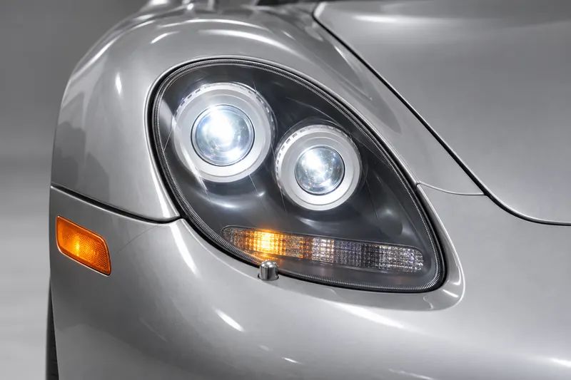 Close-up of a Carrera GT headlight cluster on silver bodywork
